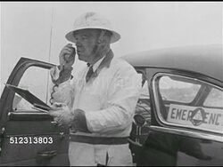 1951: WHAT-IF SCENARIO: SYRACUSE 'AFTER': CU Male hand holding Geiger counter in smoke, fog, mist. Man in white using two-way radio, 'radiation safe' OPS CENTER: Passing on 'All Clear' message. 1950s Horror, 1950s Sci-fi, Red Scare, McCarthyism. Instructional Video