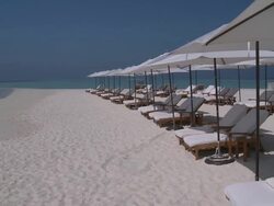 Beach chairs and parasols at the Four Seasons Resort, Landaa Giraavaru, Baa Atoll, The Maldives Stock Footage
