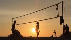 silhouette of volleyball players on the beach at sunset Stock Footage