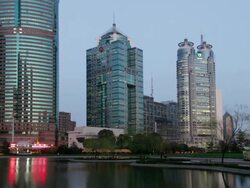 Time lapse long shot view across Huangpu River of skyscrapers in Pudong financial district/ day to night/ Shanghai Stock Footage