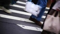 Pedestrians' legs and the stripes of a crosswalk form interesting patterns. Stock Footage