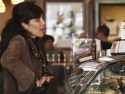 woman choosing and buying a baked good at a bakery Stock Footage