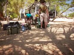 MS T/L ZI LA Shot of People packing up all terrain vehicle with equipment for expedition / Damaraland, Windhoek, Namibia Stock Footage