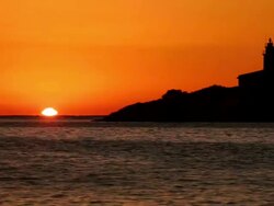 WS Sunrise over sea with light house / Mallorca, Balearic Islands, Spain Stock Footage