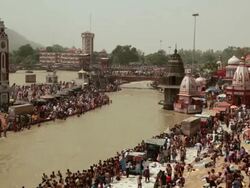 Pilgrims at riverbank, Ganges River, Haridwar, Uttarakhand, India Stock Footage