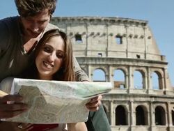 Tourists with guide and map in front of the Coliseum Stock Footage