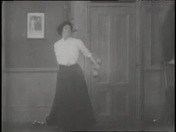 A woman hits two dumbbells together while exercising. News Clip