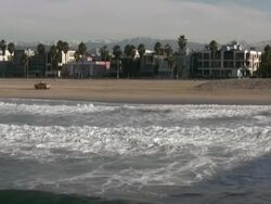 Venice Beach Winter: Snow Capped Mountains behind Surfers Stock Footage