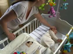 HD CRANE: Mother Stroking Her Baby In Crib Stock Footage