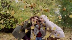 Leaves falling on mother, daughter and grandmother Stock Footage