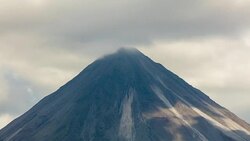 T/L Medium shot of Arenal volcano in clouds Stock Footage