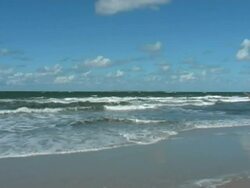 Waves on the beach - with blue sky Stock Footage