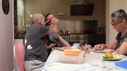 Family having lunch with disabled son Stock Footage