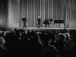 1951 Wide shot Violinist Jascha Heifetz and pianist standing in front of audience and walking off stage after performance/ USA  Stock Footage