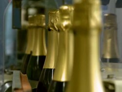 CU Champagne bottles on production line / Wiltingen, Saar-Valley, Rhineland-Palatinate, Germany Stock Footage