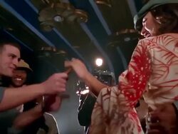 Slow motion low angle medium shot tracking shot famous couple walking past bodyguard through bunch of groupies and photographers Stock Footage