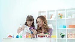 HD: Mother and daughter making origami. Stock Footage