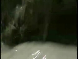 ECU dirty, grey water rushing past Stock Footage