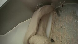 A technician pulls dough from a mixer. Stock Footage