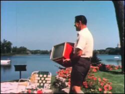 1950s suburban family amazed at portable TV Stock Footage