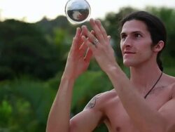 CU Shot of a man manipulating and playing with silver ball / Montezuma, Costa Rica Stock Footage