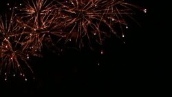 Colorful fireworks explode in the night sky. Stock Footage