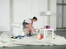 Young woman throwing red paint onto white wall Stock Footage