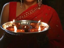 CU TU Young woman with oil lamps plates  smiling / Singapore Stock Footage