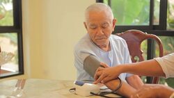 doctor measuring blood pressure of senior asian man patient Stock Footage