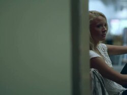 Panning slow motion shot of teenage girl sitting by locker missing part of left arm. Stock Footage