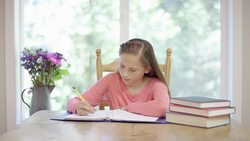 Young elementary aged girl doing homework Stock Footage