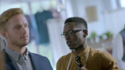 Clothing store clerk measures customer's sleeve length and marks jacket for alterations Stock Footage