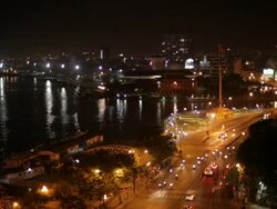 WS HA LD Traffic Along Busy Road Next to Saigon River at Night / Vietnam Stock Footage
