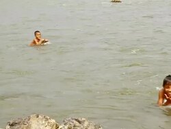 MS SLO MO Shot of two boys enjoying swimming in river/ Ou river, Luang Prabang, Laos Stock Footage