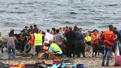 Syrian migrants fleeing the war and escaping to Europe, landing on the Greek island of Lesvos on the north coast at Efthalou. Up to 4,000 migrants a day are landing on the island and overwhelming the authorities. They are traficked by illegal Turkish peopl Stock Footage