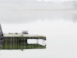 MS to CU shallow depth of field young couple running along jetty in pouring rain Stock Footage