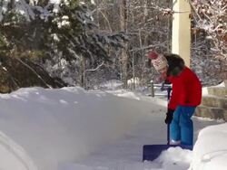 Young girl Shoveling snow on walkway Stock Footage