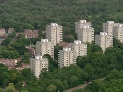 Aerial wide shot pan Roehampton tower blocks surrounded by trees / Surrey, England Stock Footage