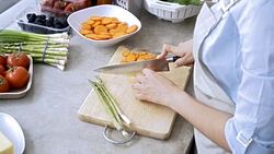 Unrecognisable woman chopping a carrot for her meal Stock Footage