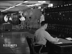 1947: CLEVELAND POWER PLANT: OHIO: WS Power plant, smoke stacks. INT VS Males working, checking electric panels. DRAMATIZATION: VS Two engineers talking about increasing power. Power station, electricity, generator, Global Warming, alternative energy, OH Instructional Video