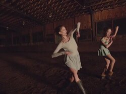wide shot of two dancers dancing in wooden barn Stock Footage