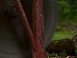 Extreme close up of loader/slasher as it saws through a log. Stock Footage