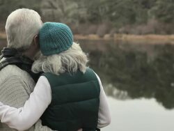 Loving mature couple by lake Stock Footage