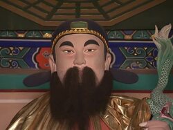 A woman bows and prays before a Taoist idol in Beijing. Stock Footage