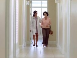 MS PAN View of female patient in escorting into medical facility / Miami, FLORIDA, USA Stock Footage