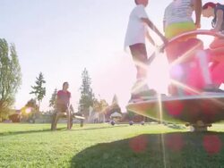 MS Group of kids playing on merry go round on playground Stock Footage