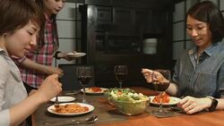 Three young women preparing food in the kitchen Stock Footage