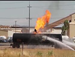 Firefighters took a bold step Wednesday to drain a burning propane tanker and prevent the rail car from blowing up as thousands of people were forced from their homes for a second day. News Clip