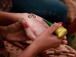Two young women applying henna, Haryana, India Stock Footage