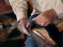 MS TU boot maker stretching vamp over sole of cowboy boot Stock Footage